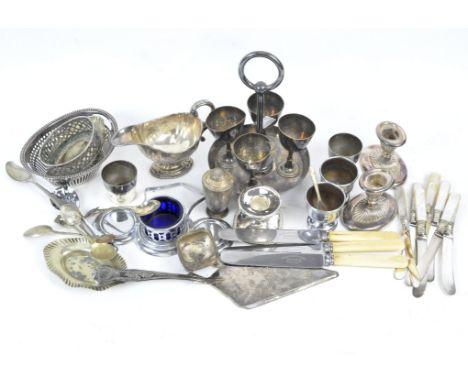 An assortment of silver plated wares, including egg cup stand. squat candlestick, sauce boat and more