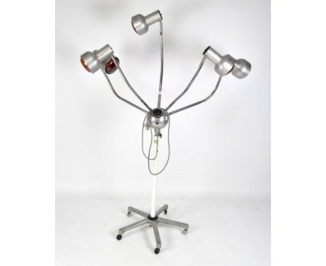 A retro lamp, composed of five individual lights, each positioned on the ends of moveable branches, attached to an extendable