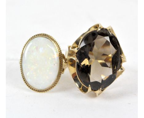 Two ladies 9ct gold dress rings, one set with a cabachon opal, the other a large claw set stone, combined weight approximatel