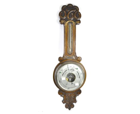 An early 20th century oak barometer with carved scroll and foliate details, height 83cm