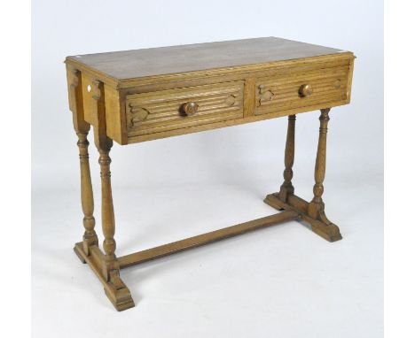 An early 20th century oak console table, raised upon turned supports with splayed feet, with two drawers to the front, 76cm x