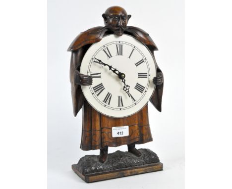 A contemporary carved wooden clock, the white dial with Roman numerals, the case modelled as a devious gentleman in a robe, h