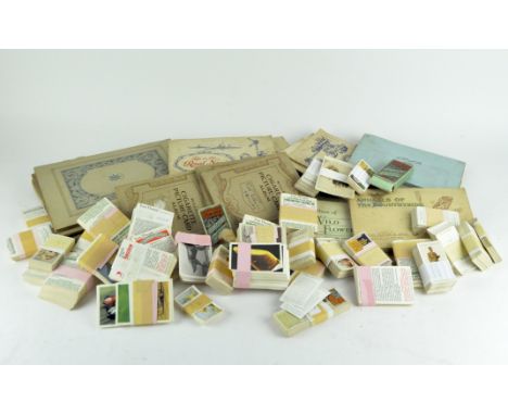 A large collection of Wills and John Player cigarette cards, depicting a range of subjects including figures, animals and arc