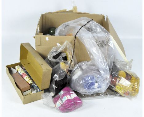 A collection of sewing tools and materials, including wool, needle cases, crochet hooks and more