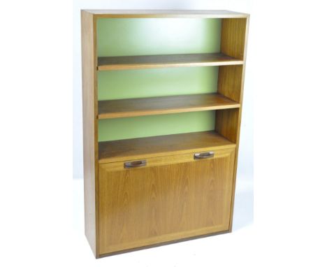 A contemporary teak cabinet, featuring three shelves above a twin handled drawer opening to reveal a glass shelf, 129cm x 84c