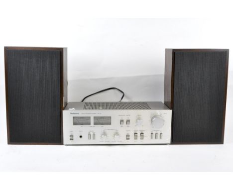 A pair of speakers and a technics stereo integrated amplifier, model SU-72, the speakers of rectangular form in wooden case