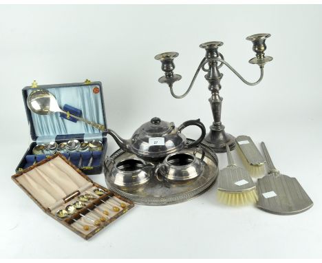A selection of 20th century silver plated wares, to include a candlestick, brushes, a hand mirror, boxed cutlery, an oval ser