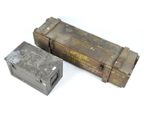 A wooden ammunitions box and a metal trunk, the first with yellow lettering reading 'The Commanding Officer... near Salisbury