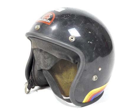 A vintage motorcycle helmet, having a Centurion badge to the front