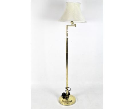 A contemporary floor lamp, the gilt metal structure supported on a circular base, with a cream shade, height (including shade