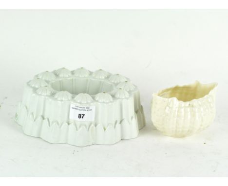 Two items of vintage ceramics. comprising a white glazed Shelley jelly mould and a Beleek cream glazed sea urchin dish, heigh