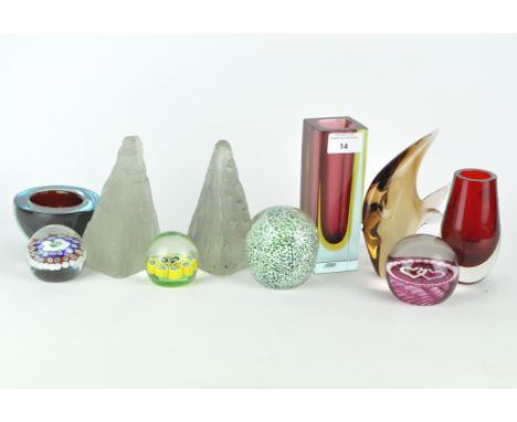 A collection of contemporary glass paperweights and two-colour vases, the paperweights are of assorted sizes and shapes and i