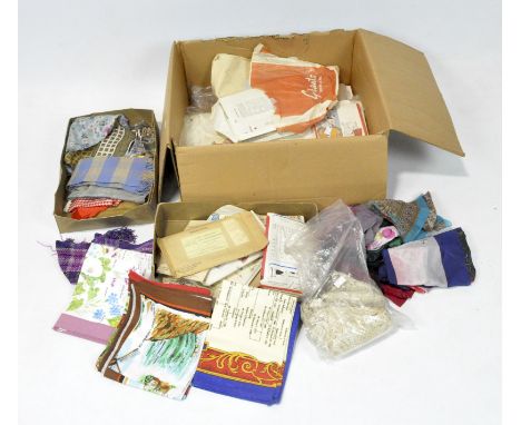 A collection of sewing and fashion related items, including silk scarves, tablecloths, vintage sewing patterns, fabric and mo
