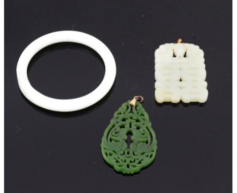 Two jade pendants, a mutton fat colour pendant carved with a bat over a symbol, 9 ct gold mount and a nephrite jade pendant w
