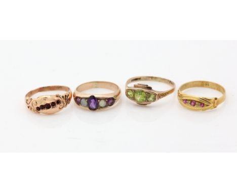 A group of Edwardian gem set  gold rings, a five stone with set amethyst and opal, another with peridot, two others with smal