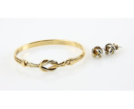 Gold bangle, knot clasp detail, in 9 ct hallmarked Birmingham  and a pair of base metal knot stud earrings.    CONDITION9 ct 