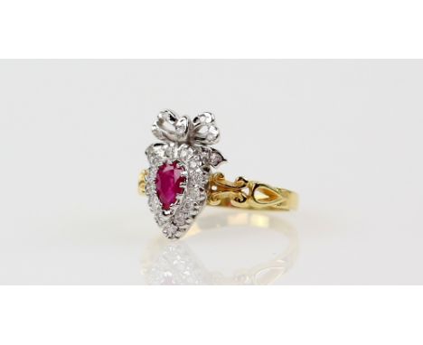 Ruby and diamond dress ring, pear cut ruby set in border of diamonds, surmounted by diamond set bow, set in 18 ct yellow gold