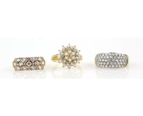 Three gem set rings, band ring with trellis detail set with aquamarine and pink sapphire, an opal and pale aquamarine cluster