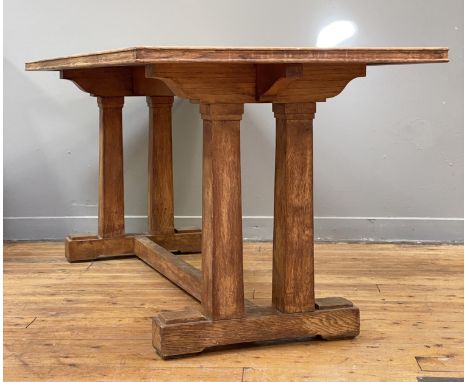 An oak refectory dining table in the Arts and Crafts taste, circa 1930's, the panelled and cleated rectangular top raised on 