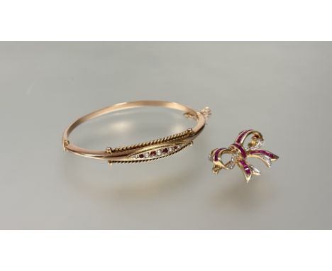 An Edwardian ruby and seed-pearl set 9ct gold bangle, hinged, set to the centre with four round-cut rubies spaced by graduate