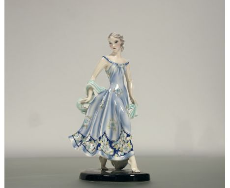 Claire Herczeg (1906-1997) for Goldscheider, a glazed earthenware figure of a girl in a floral print dress, c. 1935, on an ov