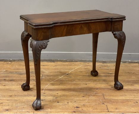 A mahogany fold over card table of George II design, circa 1920's, the top with lobed corners opening to a baize lined playin