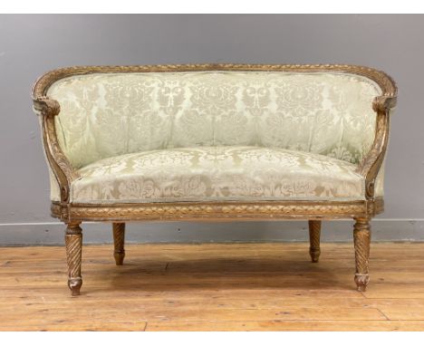 A 19th century French gilt wood and gesso boudoir sofa or canape, the lattice-moulded and curved crest rail having scrolled a