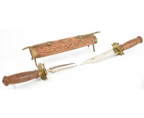 An Eastern knife and fork, contained in carved hardwood and brass double ended case, length 44cm.