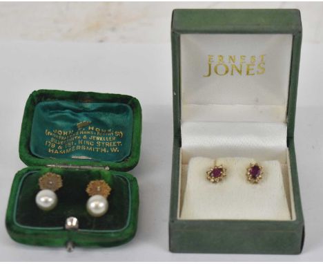 A pair of 10ct yellow gold ruby set earrings, together with a pair of 9ct yellow gold earrings set with small central white s