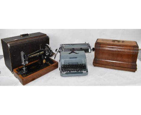 A cased Singer sewing machine, together with an Imperial typewriter and another cased sewing machine (3). 