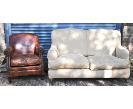 An upholstered sofa on turned supports, also a modern leather armchair (2). 