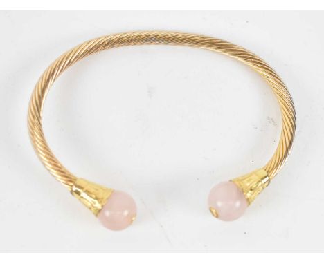 An Indian style yellow metal quartz set bangle. 