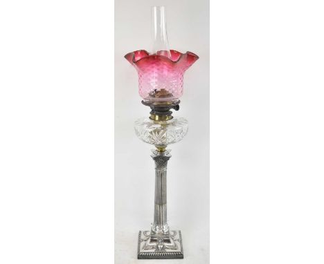 A late 19th century silver plated oil lamp with cut glass well and cranberry glass shade, height to top of fitment 47cm, heig