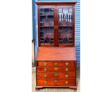 A 19th century mahogany bureau bookcase, the upper section with pair of astragal glazed doors enclosing fitted shelves and pi
