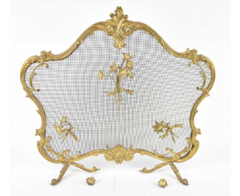 An ornate gilt metal and mesh fire screen, relief decorated with flowers, height 65cm, width 71cm. 