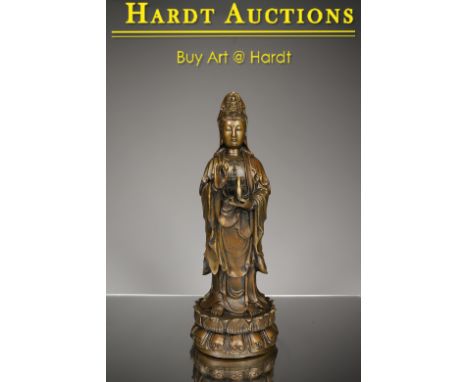 BronzeChina , 20th centuryDimensions: Height 30 cm Wide 11 cm Depth 11 cmWeight: 1742 gramsA standing Guanyin statue on a dou