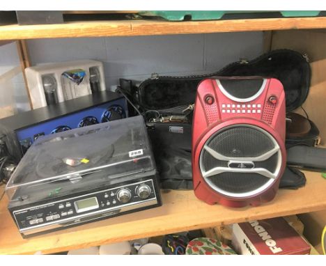 A shelf of assorted musical ware, to include a violin and karaoke etc.