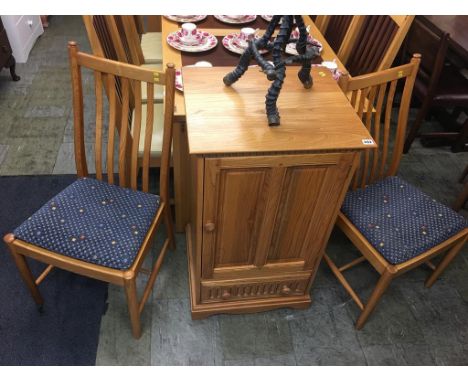 A pair of Ercol Golden Dawn chairs and a cabinet