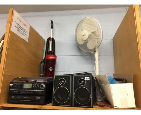 A shelf of assorted, to include a fan and a Steepleton stereo etc.