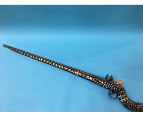 A mother of pearl inlaid North West Frontier flintlock muskett, East India Lion emblem on lock plate and bears date 1815, 132