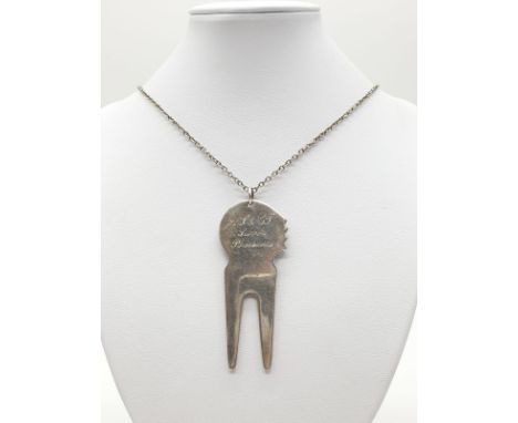A golfing tool called a pitch repairer (dated 1999) on a 70cm long silver chain, weight 30.53g and pendant size 7x3cm approx