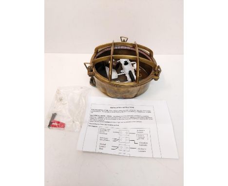 A circular brass wall light styled as a ship's bulkhead light. Unused, as new. 20cm diameter. CE mark. 
