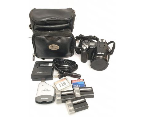 A Nikon Coolpix 5700 digital camera. Includes charger, lens cap and case. As found. 