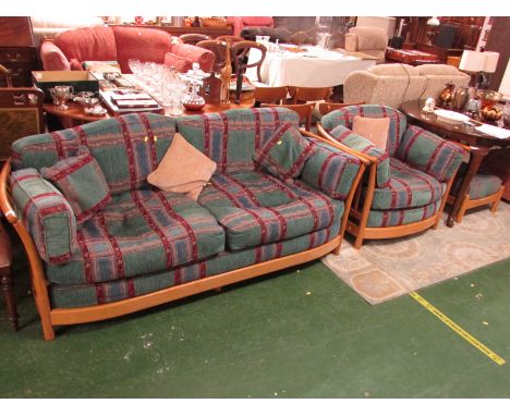 ERCOL LIGHT ELM FRAMED TWO-SEATER SOFA AND MATCHING ARMCHAIR AND FOOTSTOOL, WITH GREEN BLUE AND PURPLE PATTERN CUSHIONS