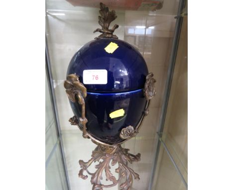 BLUE GLAZED CERAMIC URN ON A FOLIATE BRASS BASE