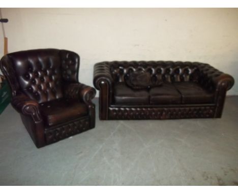 A BROWN LEATHER THREE SEATER CHESTERFIELD SOFA AND WING BACKED CHAIR (TWO PIECE SUITE), Sofa L 185 cm, D 88 cm, H 67 cm, seat