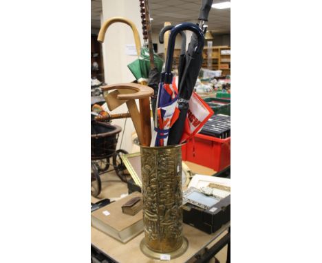 A BRASS STICK STAND ALONG WITH SIX UMBRELLAS AND TWO WALKING STICKS AND A SET SQUARE