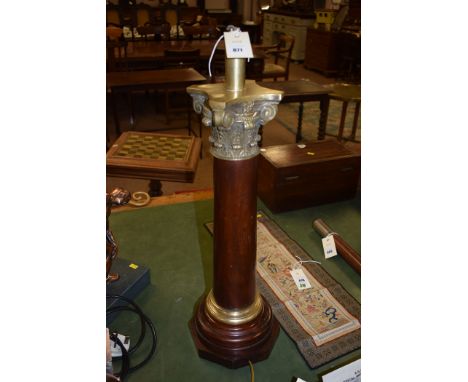 A brass and mahogany Corinthian column pattern table lamp.