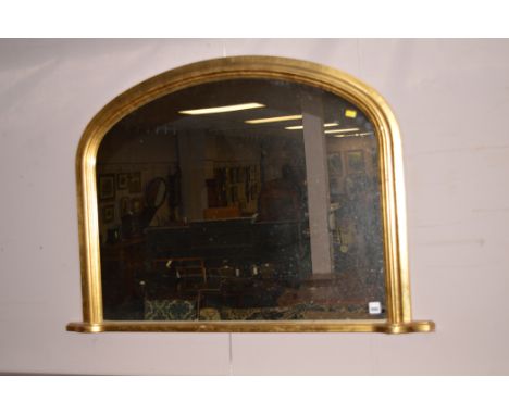 Gilt arched over mantel mirror, 103cms wide.