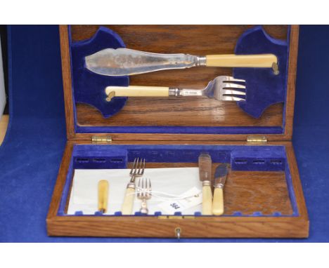 A pair of George V silver and ivory handled fish servers; and a pair of fish knives and forks, by Harrison Bros. & Howson, Sh